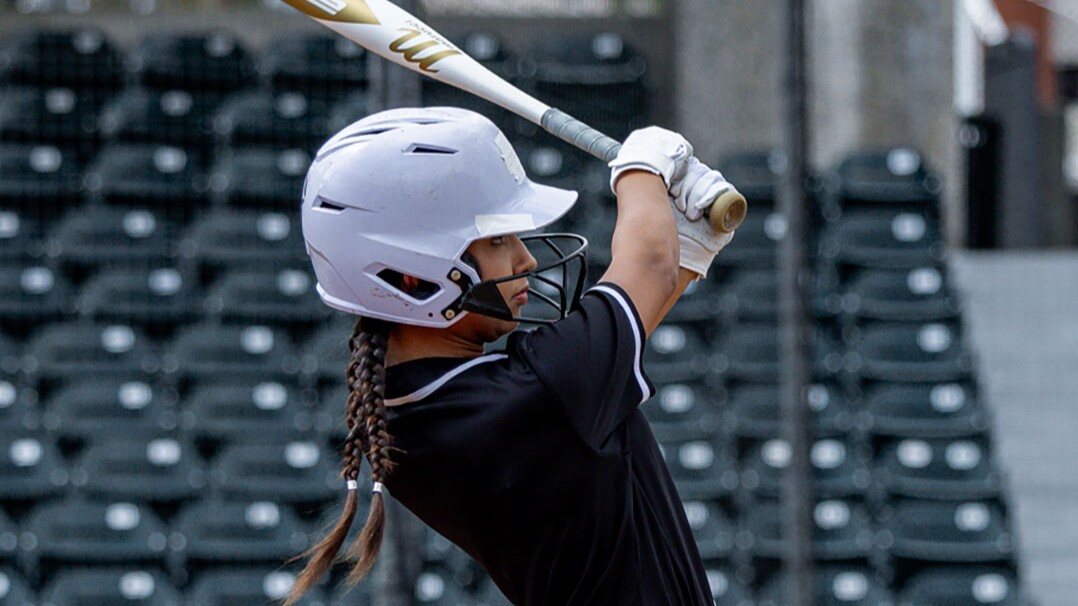 softball player swinging a bat