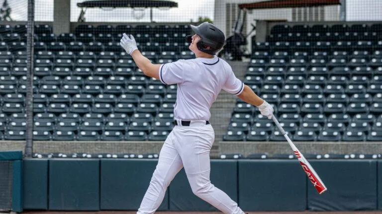 Image of a baseball player following through after hitting the ball